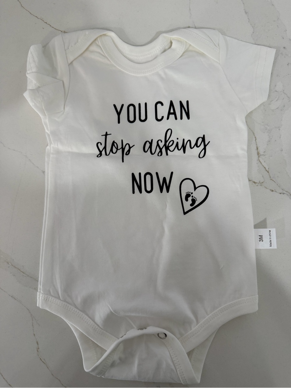 White Baby Bodysuit with 'You Can Stop Asking Now' Print